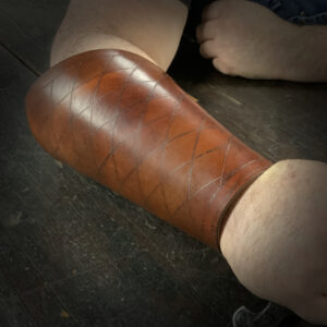 brown leather arm bracers hand tooled